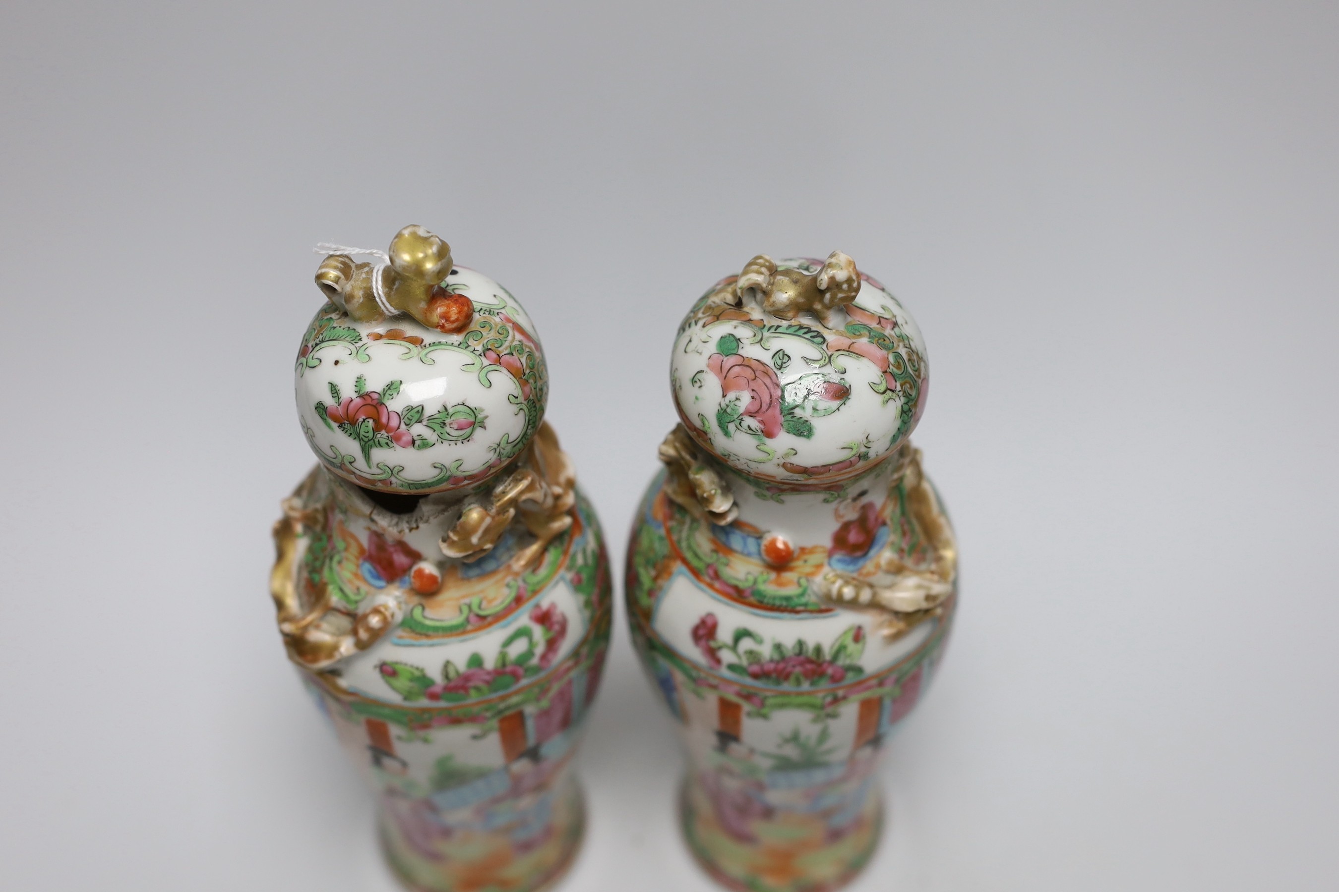 A pair of 19th century Chinese famille rose vases and covers, 24cms high